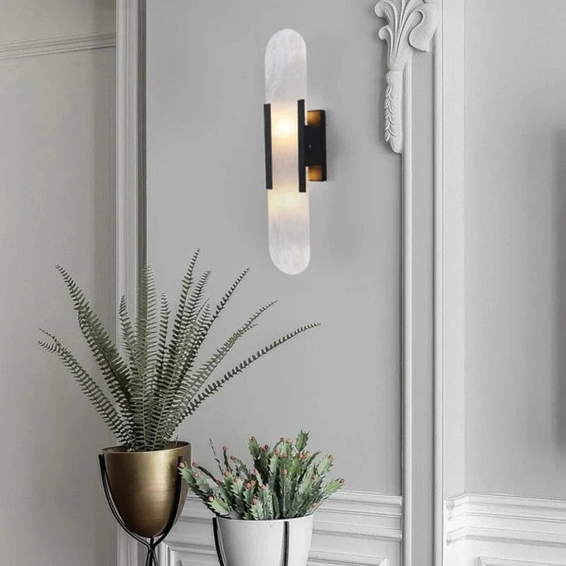 "Modern black and gold LED wall lamp with oval Lucite crystal centerpiece, ideal for dining room lighting."