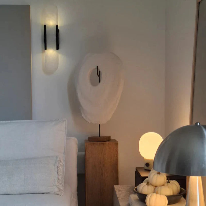 "Modern black and gold LED wall lamp with oval Lucite crystal centerpiece, ideal for dining room lighting."