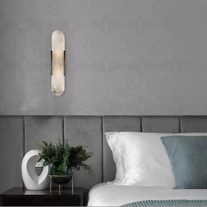 "Modern black and gold LED wall lamp with oval Lucite crystal centerpiece, ideal for dining room lighting."