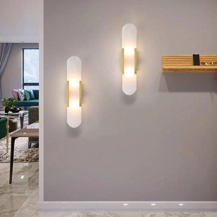"Modern black and gold LED wall lamp with oval Lucite crystal centerpiece, ideal for dining room lighting."
