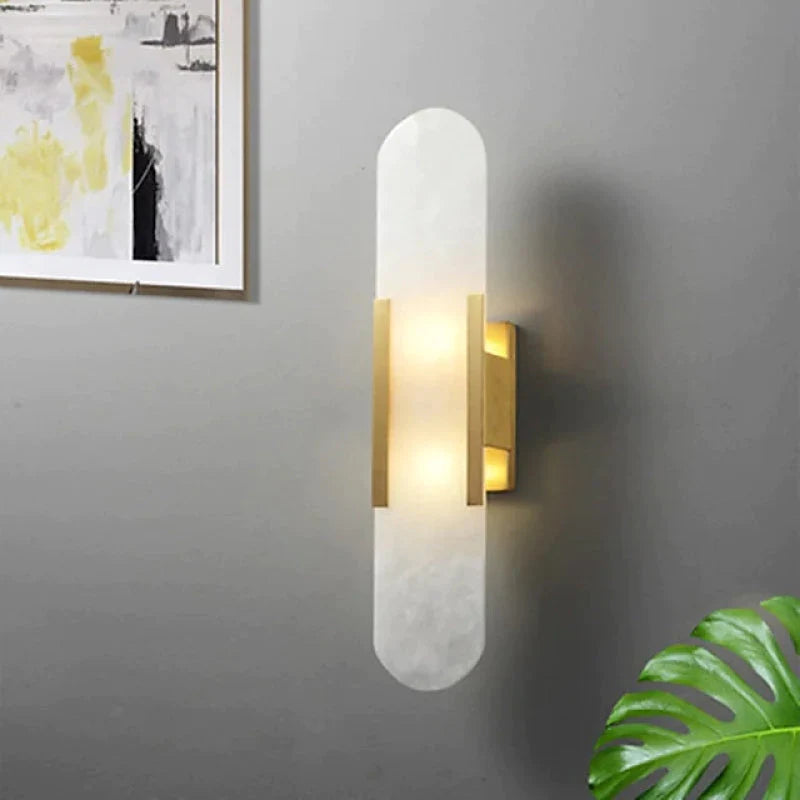 "Modern black and gold LED wall lamp with oval Lucite crystal centerpiece, ideal for dining room lighting."