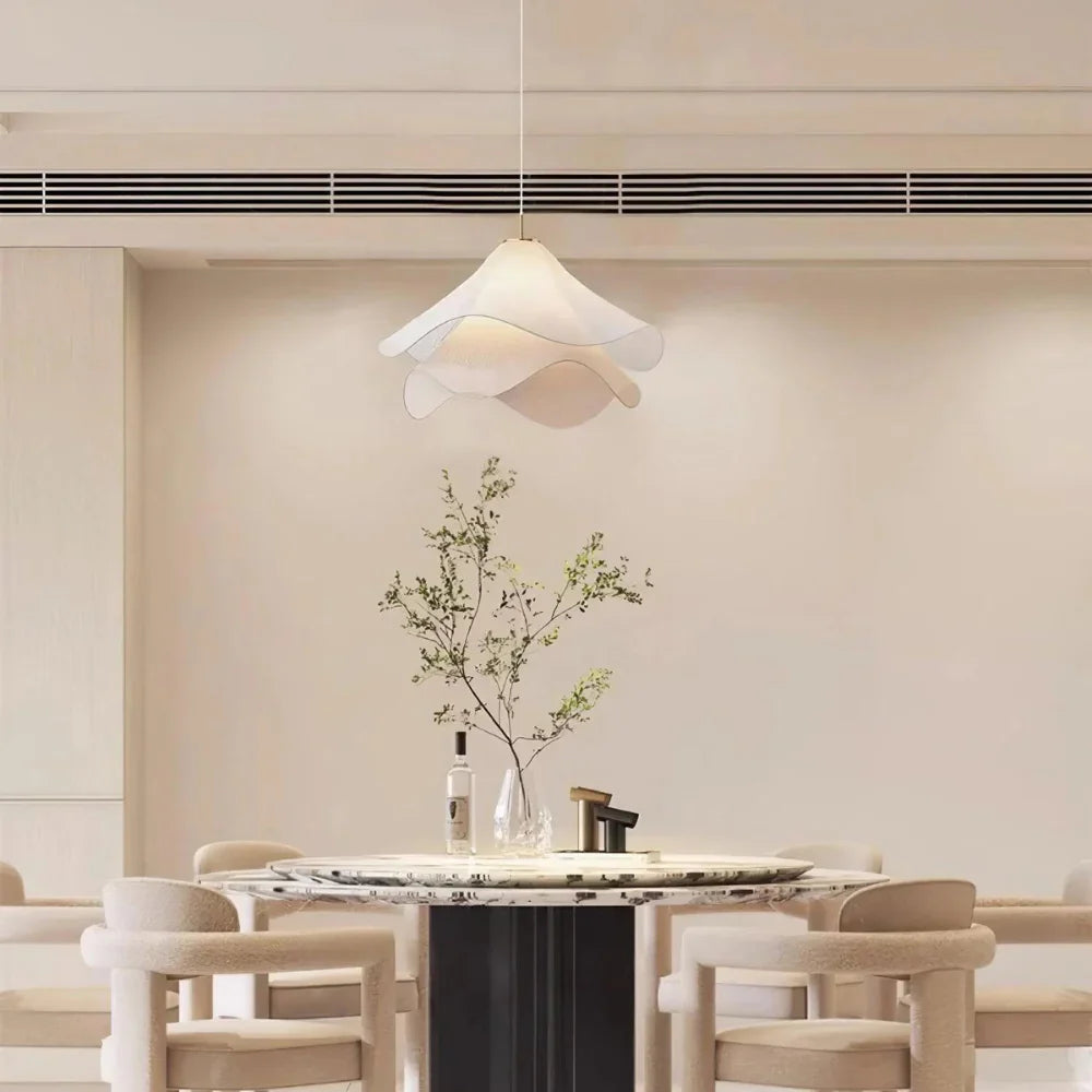 Modern white fabric flower LED pendant light with elegant design, soft glow, ideal for chic interiors, adjustable length.