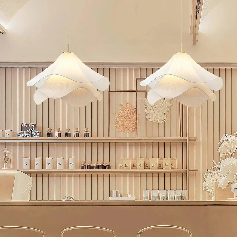 Modern white fabric flower LED pendant light with elegant design, soft glow, ideal for chic interiors, adjustable length.