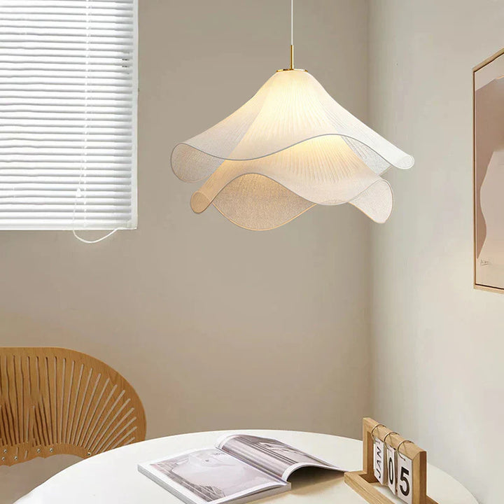Modern white fabric flower LED pendant light with elegant design, soft glow, ideal for chic interiors, adjustable length.