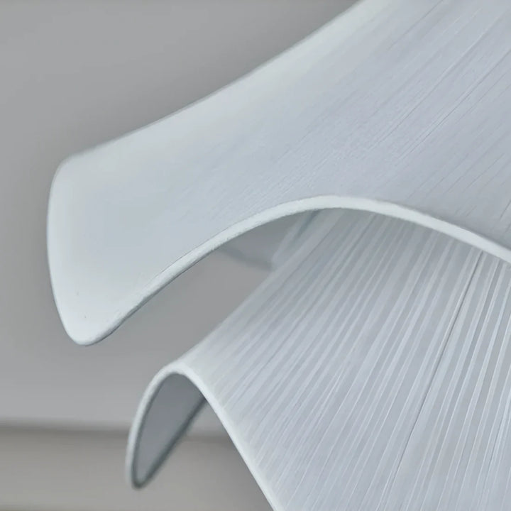 Modern white fabric flower LED pendant light with elegant design, soft glow, ideal for chic interiors, adjustable length.