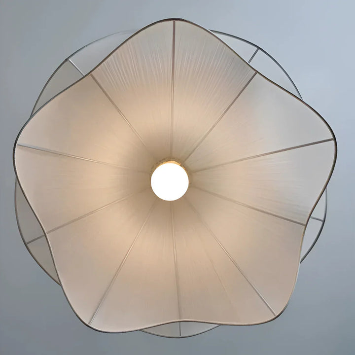 Modern white fabric flower LED pendant light with elegant design, soft glow, ideal for chic interiors, adjustable length.