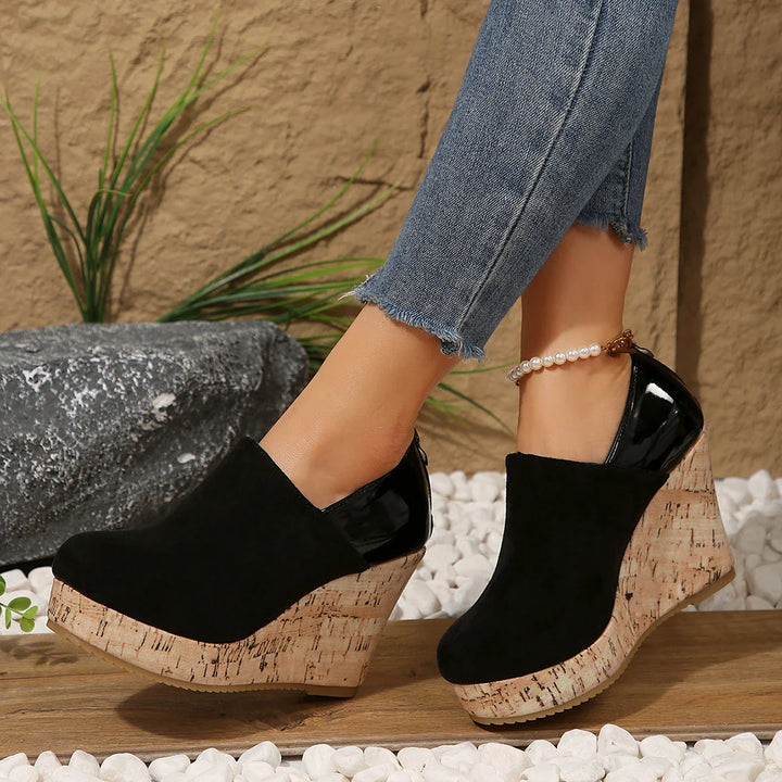 Pair of women's comfortable navy blue orthopedic wedge loafers, side view