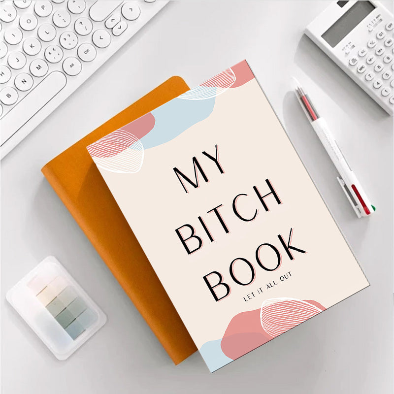 Person writing in an adult stress relief journal, practicing gratitude and self-care