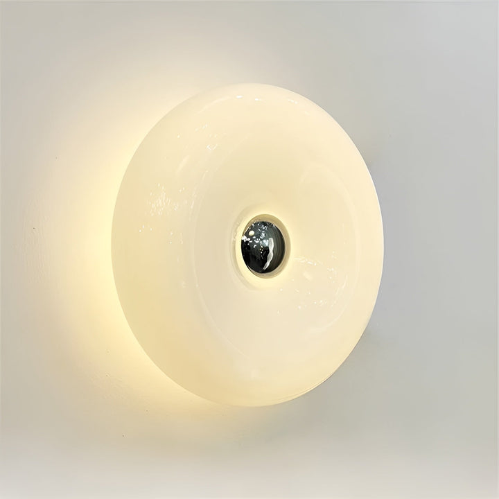 Orange donut-shaped LED lamp with warm glow, fits as a wall or table lamp, whimsical design with high-quality glass and metal