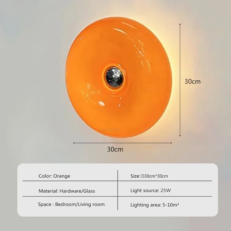 Orange donut-shaped LED lamp with warm glow, fits as a wall or table lamp, whimsical design with high-quality glass and metal