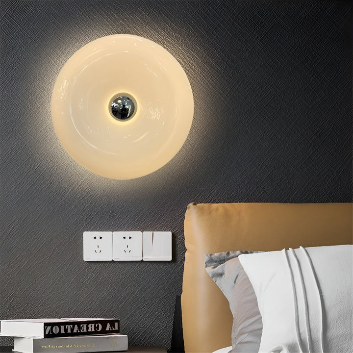 Orange donut-shaped LED lamp with warm glow, fits as a wall or table lamp, whimsical design with high-quality glass and metal