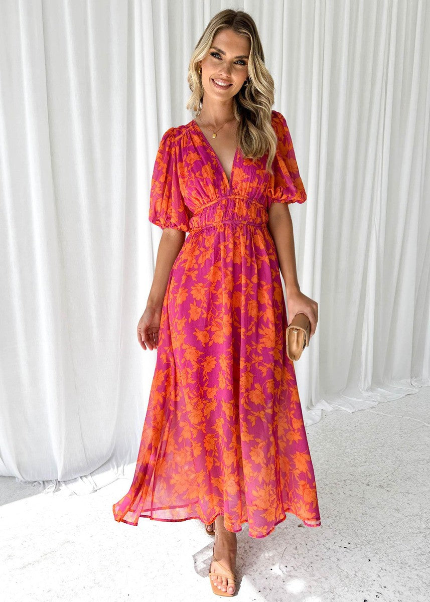 Orange floral midi dress for women, perfect for wedding guests. Features a v-neck and puff sleeves. Elegant spring fashion.
