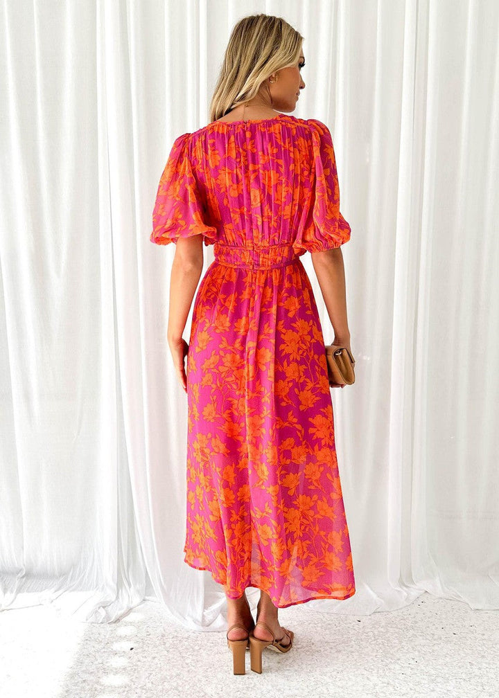 Women's orange floral midi dress with puff sleeves, a v-neck. Perfect flattering summer party & wedding guest dress.