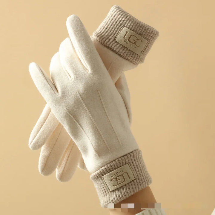 Closeup of a hand wearing a grey cashmere touchscreen glove, showing the conductive fingertips.