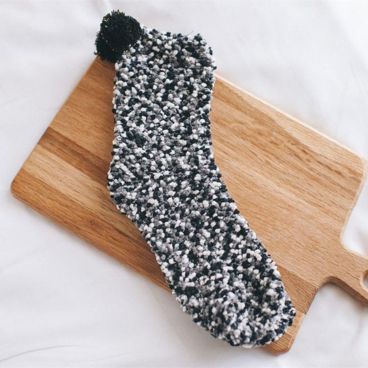 One fluffy cupcake slipper sock standing upright, emphasizing its thick, soft material and cozy feel.