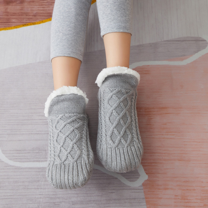 Happy feet in fluffy grey unisex slipper socks, showcasing the ultimate cozy and warm home essential.