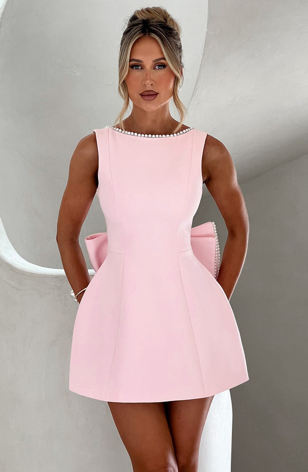 Pink structured mini dress for women, ideal for a wedding guest or cocktail party, with elegant design.
