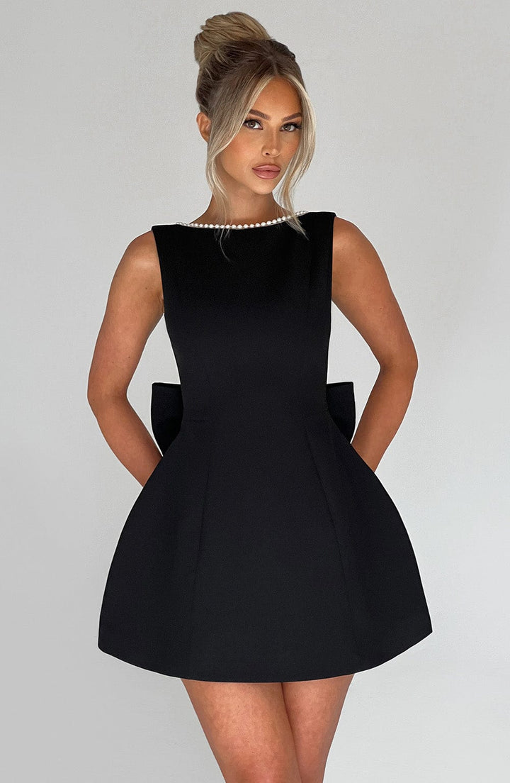 Close-up of a pink structured mini dress bodice, highlighting the fabric texture and design details.