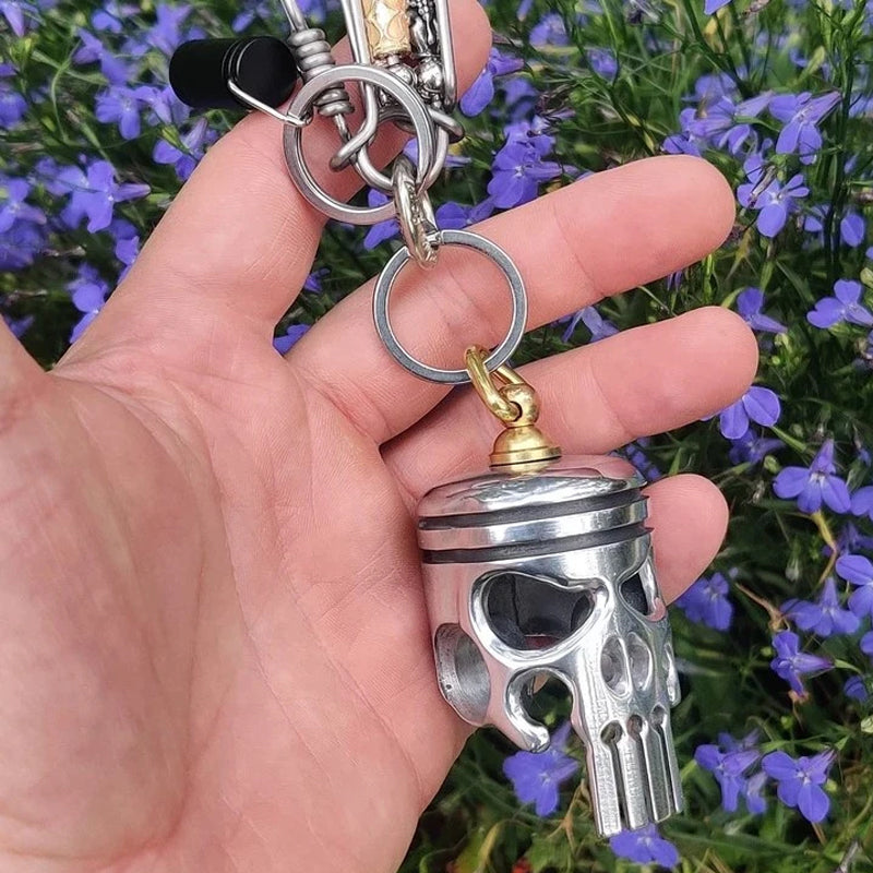 Detailed close-up of Piston Art Skull Keychain, metal, handmade, motorcycle accessory.