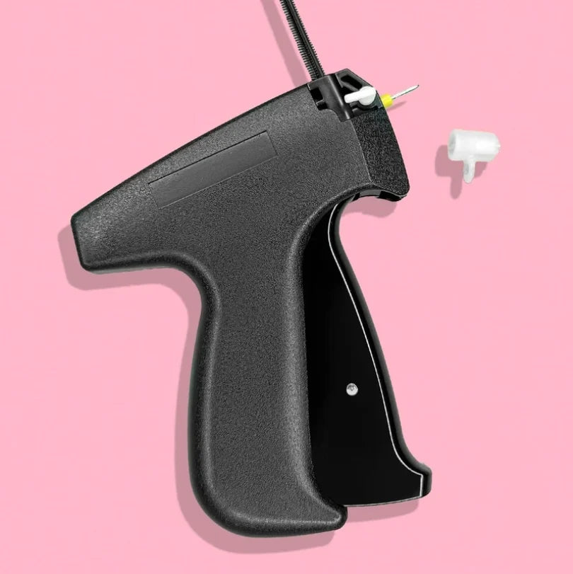 The portable fabric fixer kit, including the tool, extra needles, and a variety of fasteners