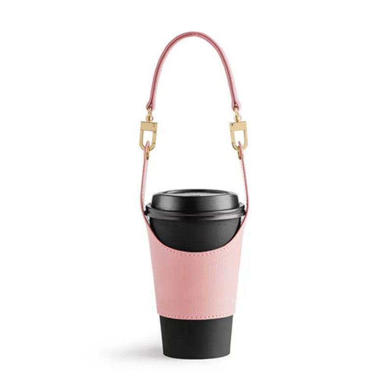 Person placing a hot coffee cup into a portable vegan leather holder, ready for travel