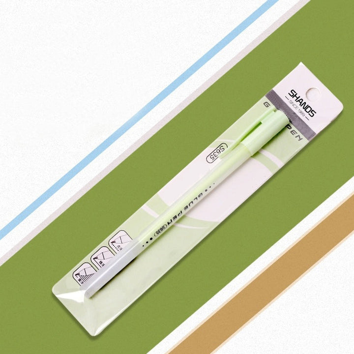 Quick Dry Precision Glue Pen alongside other artist's stationery; an indispensable crafting adhesive