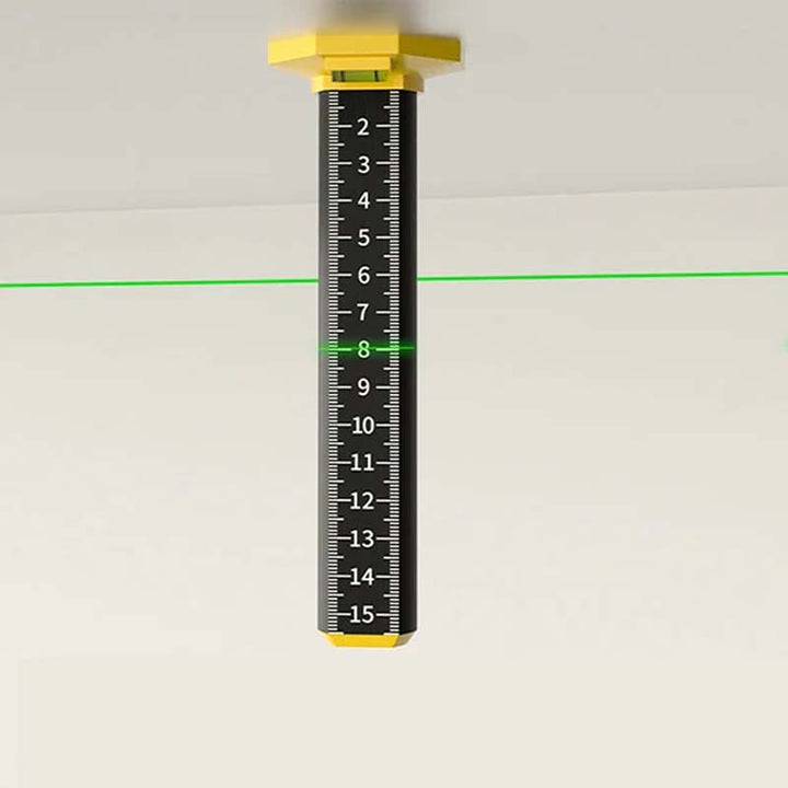 Construction worker using a magnetic level tool to check the slope of a floor for drainage.