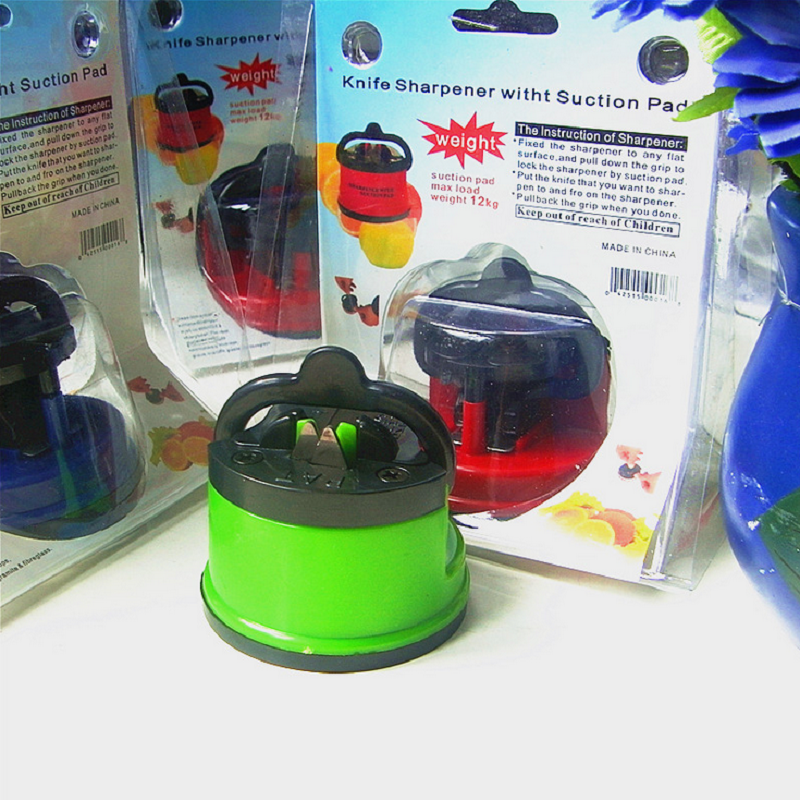 Compact kitchen knife sharpener in red, featuring a powerful suction base for stability