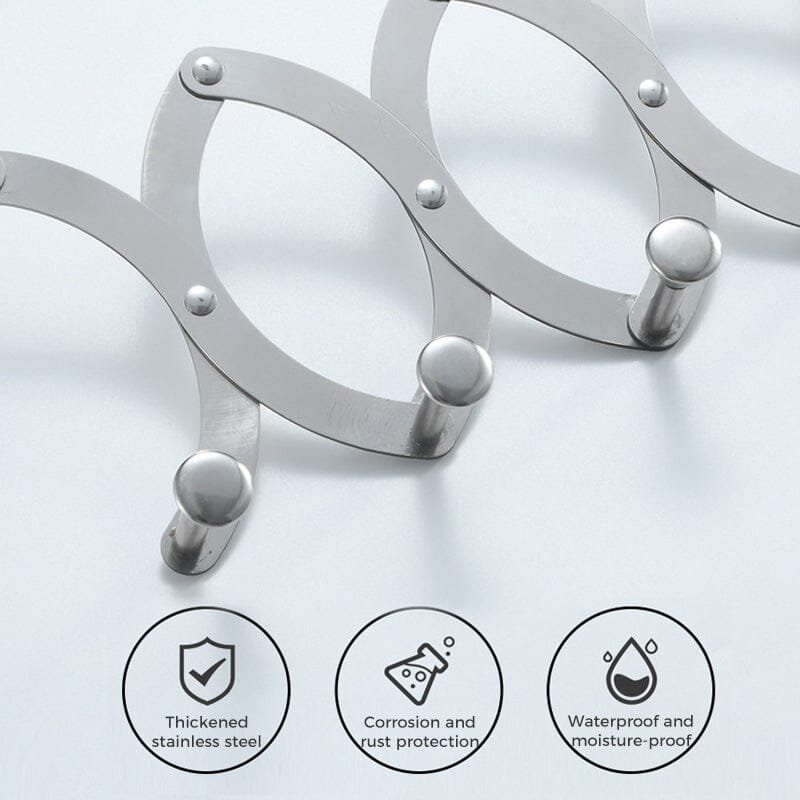 Compact metal hook rack on a door, showing its retractable feature for versatile home organization