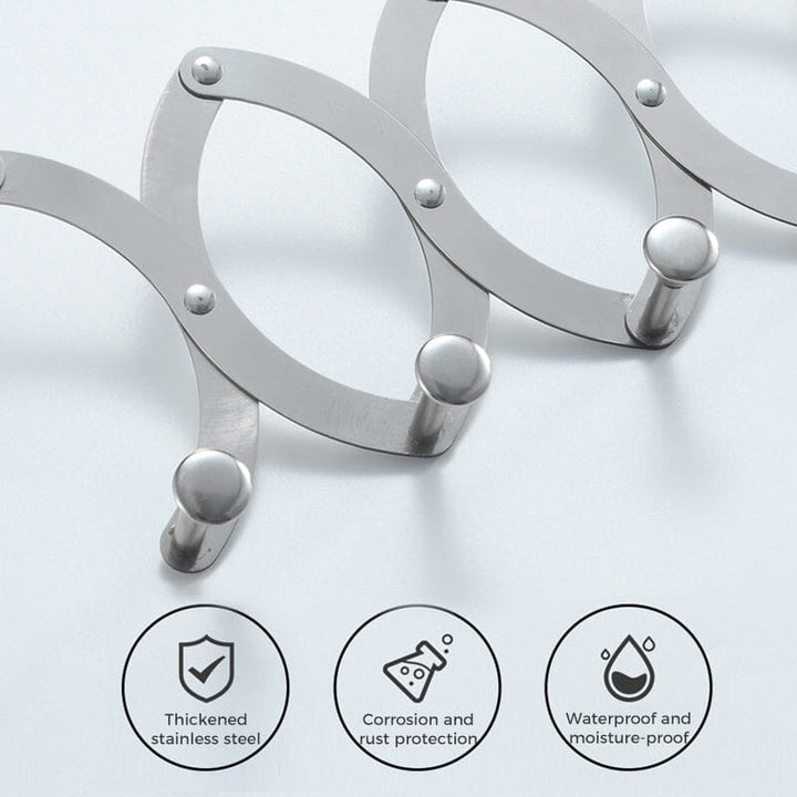 Compact metal hook rack on a door, showing its retractable feature for versatile home organization