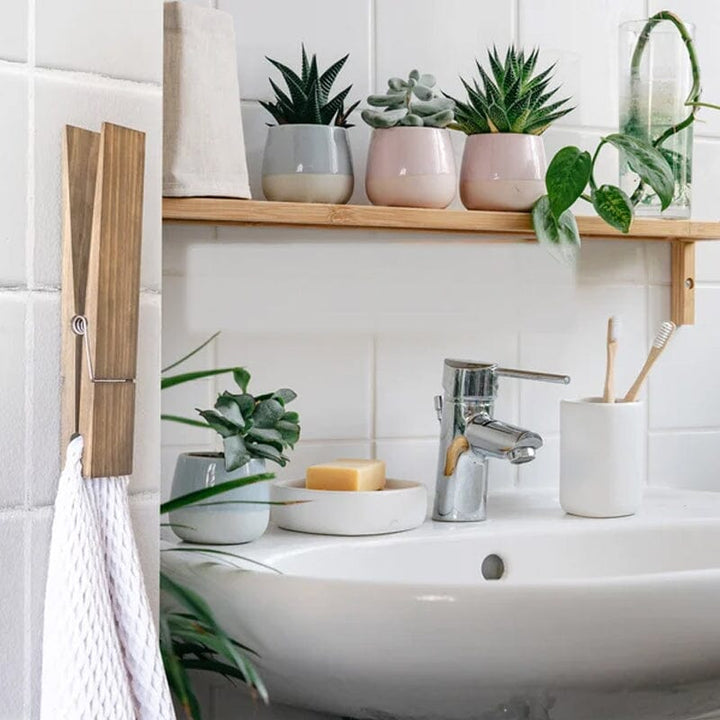 Clothespin towel holder, rustic wooden craftsmanship enhances bathroom or laundry room decor.