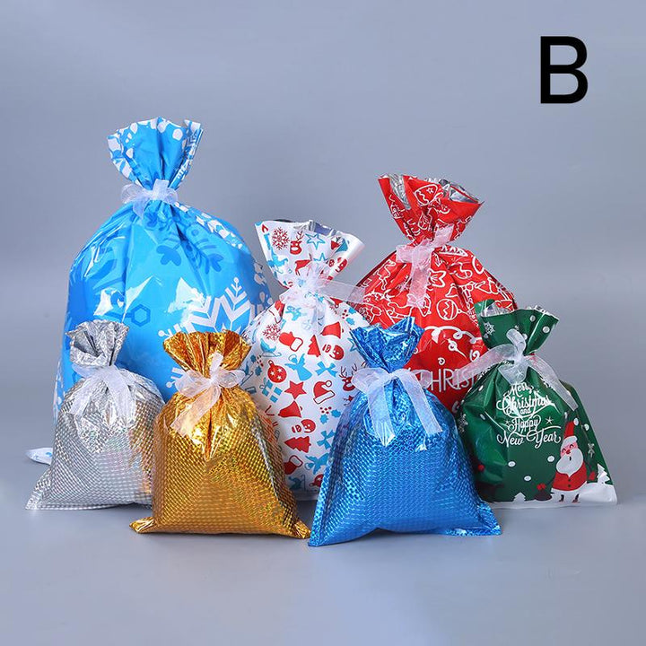 Child's hand placing a present into a red reusable Christmas drawstring gift bag, eco-friendly holiday wrapping