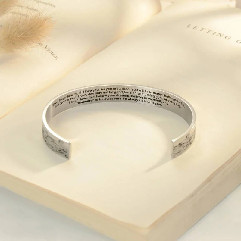 Elegant granddaughter cuff bracelet, polished stainless steel, front view of engraved message