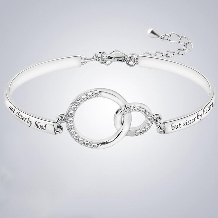 Set of two friendship adjustable bracelets, silver and gold, presented as a holiday gift for best friends.
