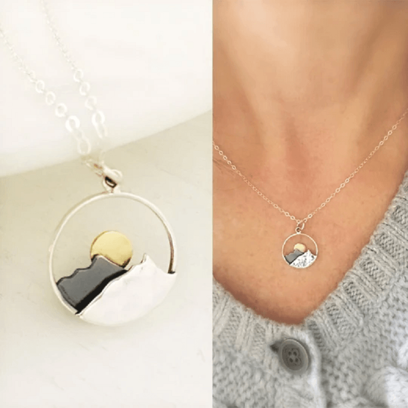 Couple's silver mountain range necklace, representing outdoor adventure and natural beauty.