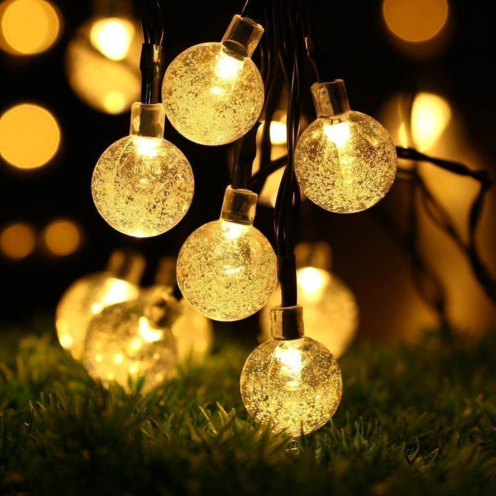 Garden path illuminated by energy-saving solar LED string lights, decorative and functional