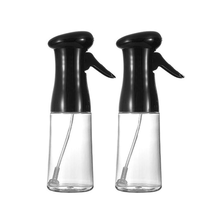 Kitchen Oil Sprayer Bottle next to a grill, showing versatility for outdoor cooking