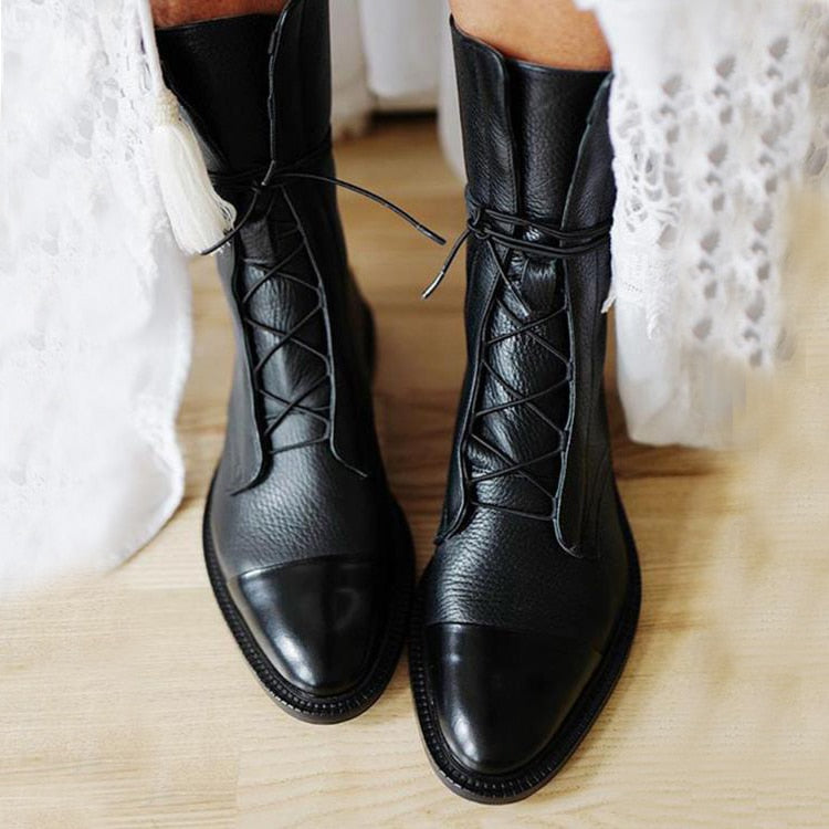 Stylish women's black leather ankle boots with sturdy laces and durable sole, perfect for winter fashion.