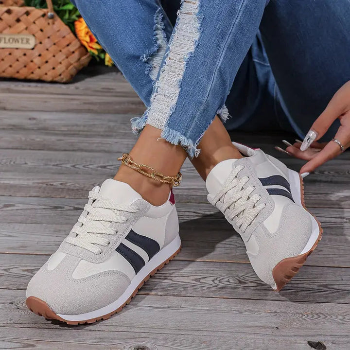 Women's vintage-style low-top sneakers. Fashionable lace-up retro shoes with a striped design for casual wear.