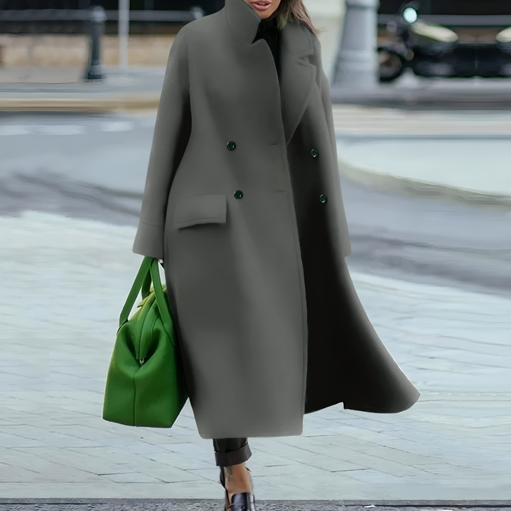 Fashionable women's long rain coat, waterproof and featuring a secure button closure.