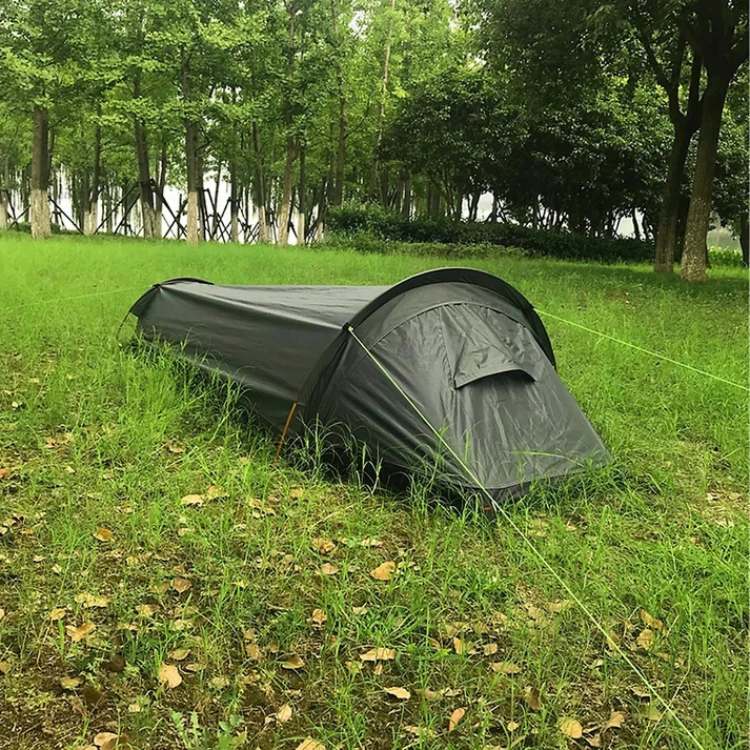 Ultralight solo backpacking tent set up in a forest, ideal for single person hiking & camping shelter.
