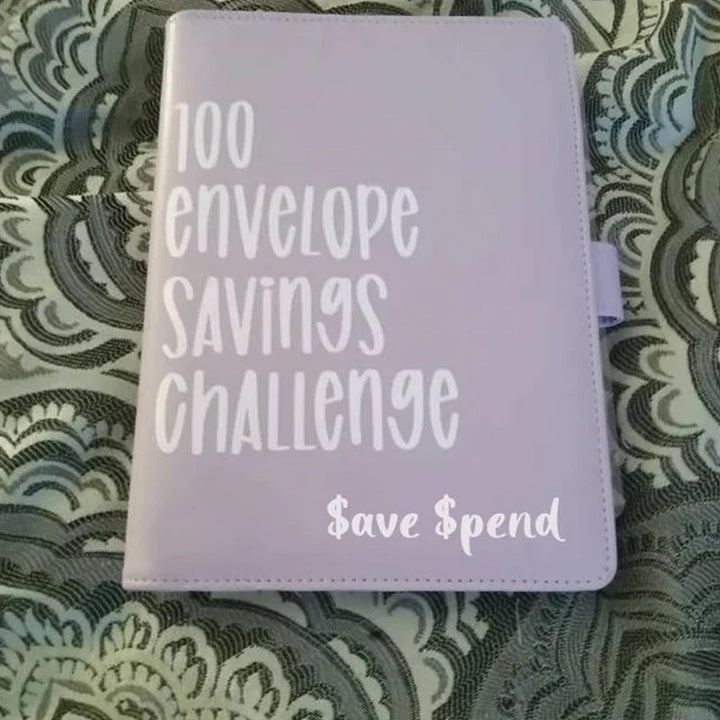 Person holding a 100 Envelope Money Savings Challenge Binder, demonstrating its portable design