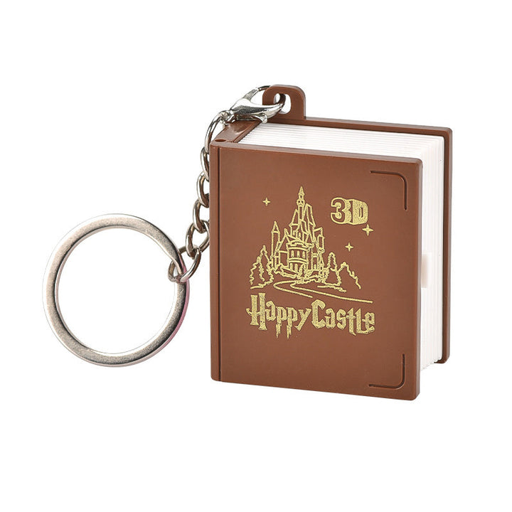 Unisex 3D Pop-Up Book Keychain displayed with other trendy accessories, a stylish gift