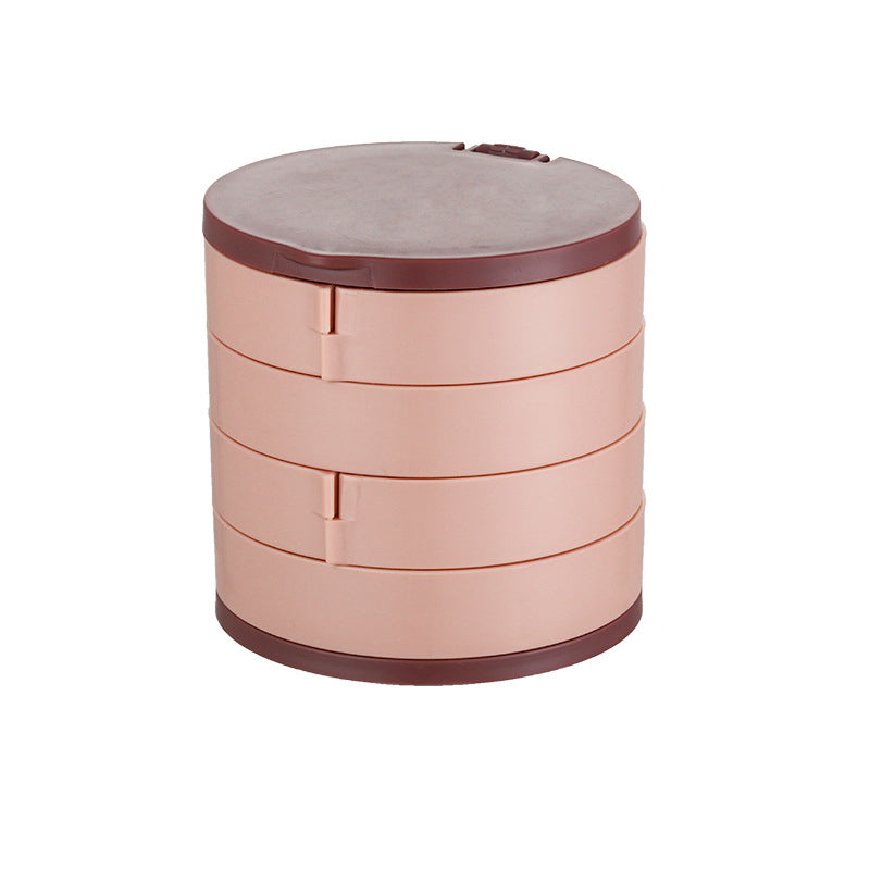 Hand placing a ring into a compartment of the 4-layer rotatable jewelry organizer, user-friendly