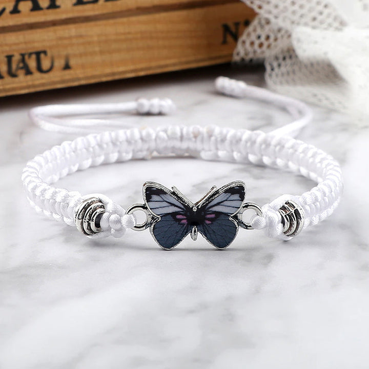 Stylish unisex black woven bracelet with a small butterfly charm, adjustable for any wrist size.