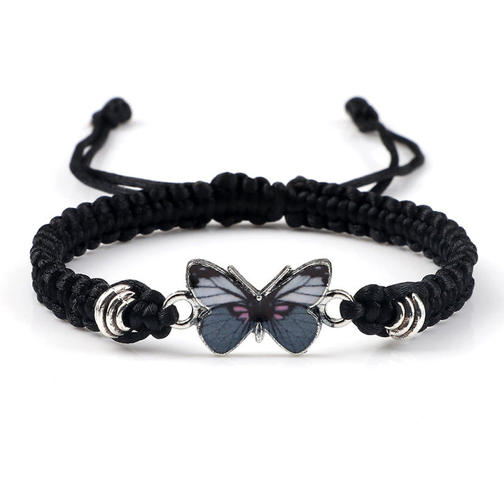Detail shot of the secure adjustable knot on a woven butterfly charm bracelet.