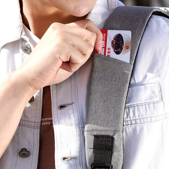Unisex model wearing an anti-theft backpack in a city. Stylish & secure daypack for commuters, students & travelers.
