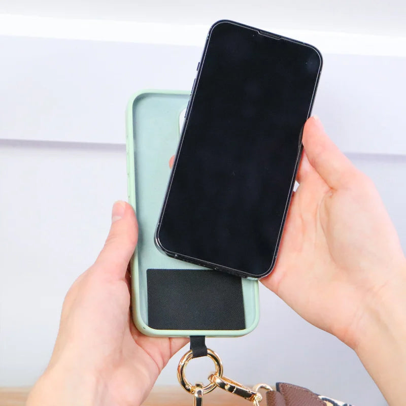 Close-up of the universal phone lanyard attachment and pouch, highlighting secure phone storage.
