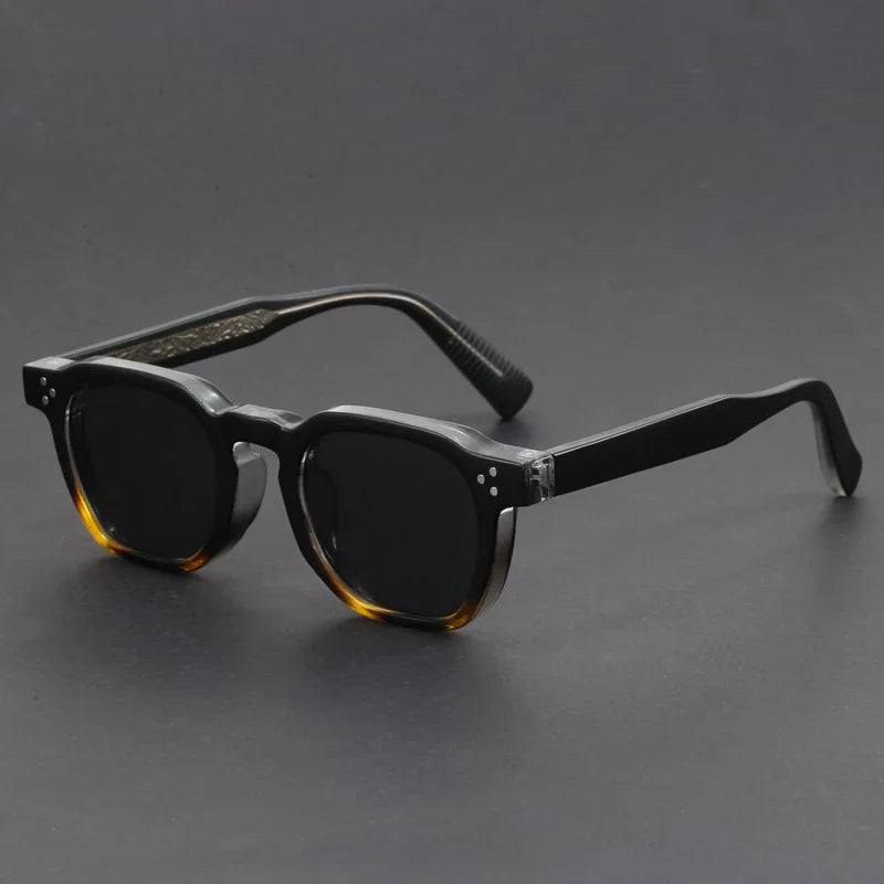 Close-up of unisex bold square sunglasses showing acetate frame detail and UV protection.