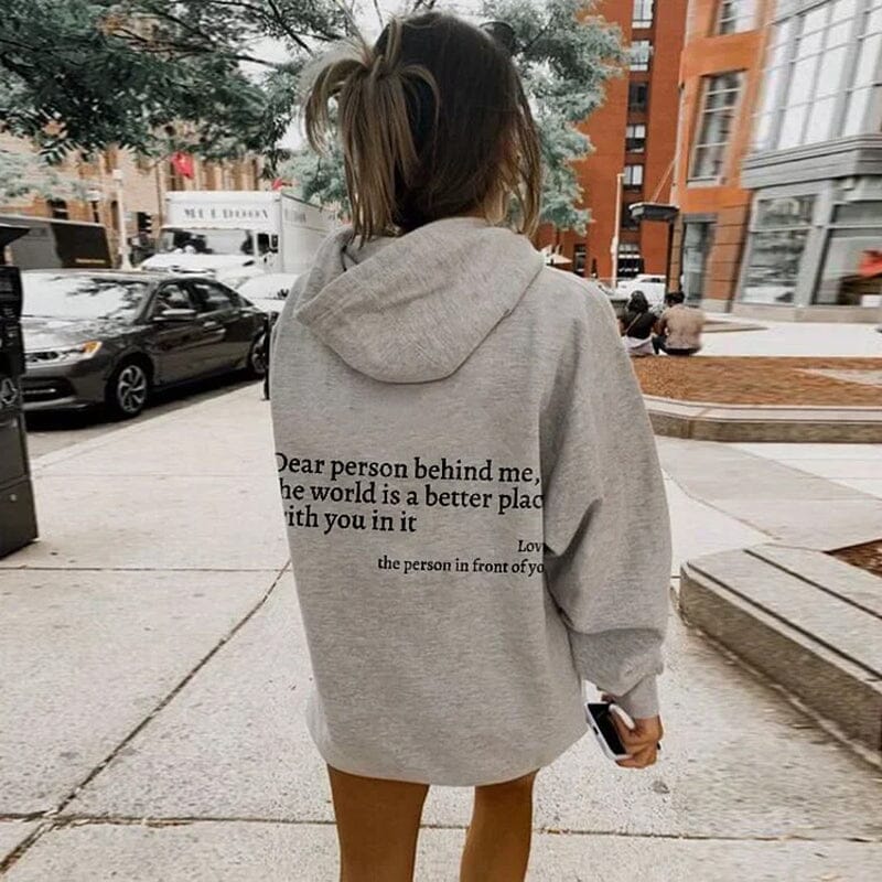 Couple laughing, both wearing 'Dear Person Behind Me' matching sweatshirts, gift idea